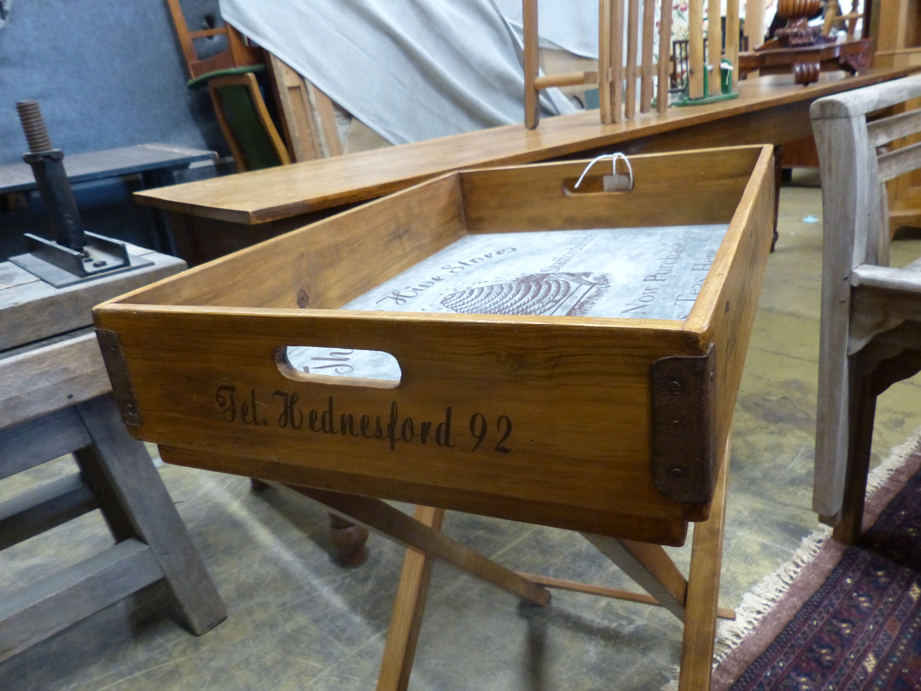 'The Bee Hive Stores', a rectangular wooden produce display tray on folding stand, width 65cm, depth 44cm, height 78cm